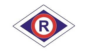 Znak graficzny pionu Ruchu Drogowego - litera R w czerwonym okręgu wpisanym w granatowy romb.