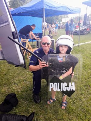 Policjant z chłopcem w wyposażeniu policjanta.