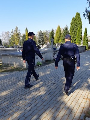 Policjanci patrolują cmentarz.